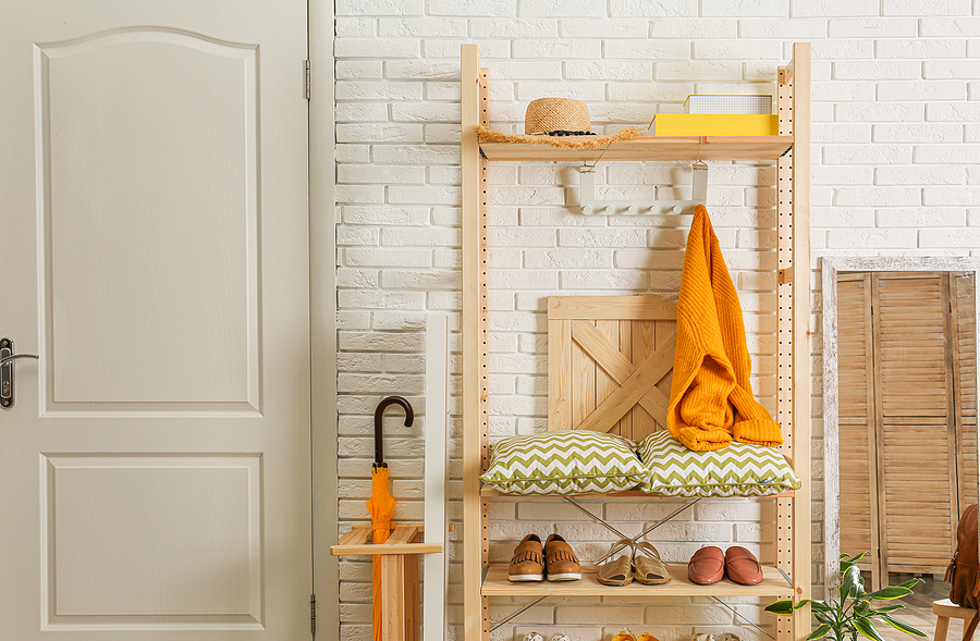 A colorful shelving unit in the entryway of an apartment.